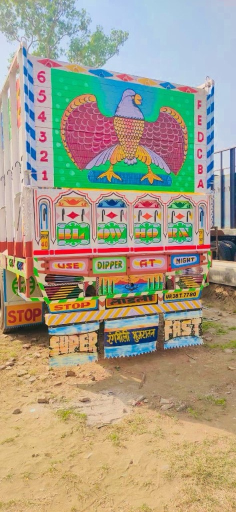Decorated rear of completed truck body with traditional truck art